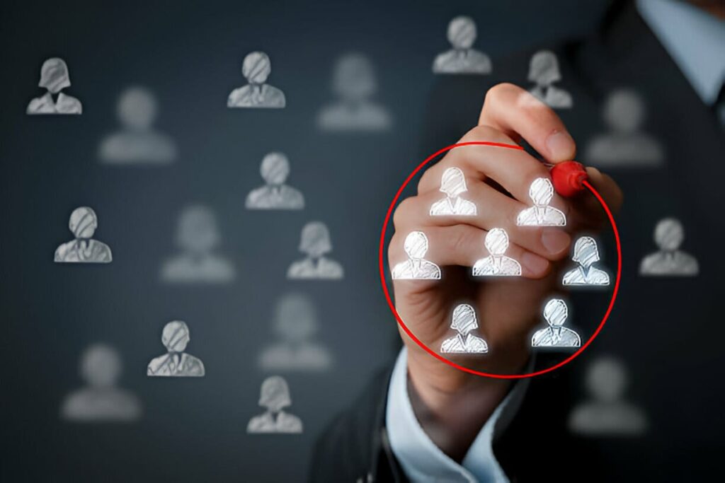 A man circling out diverse group of people as target market